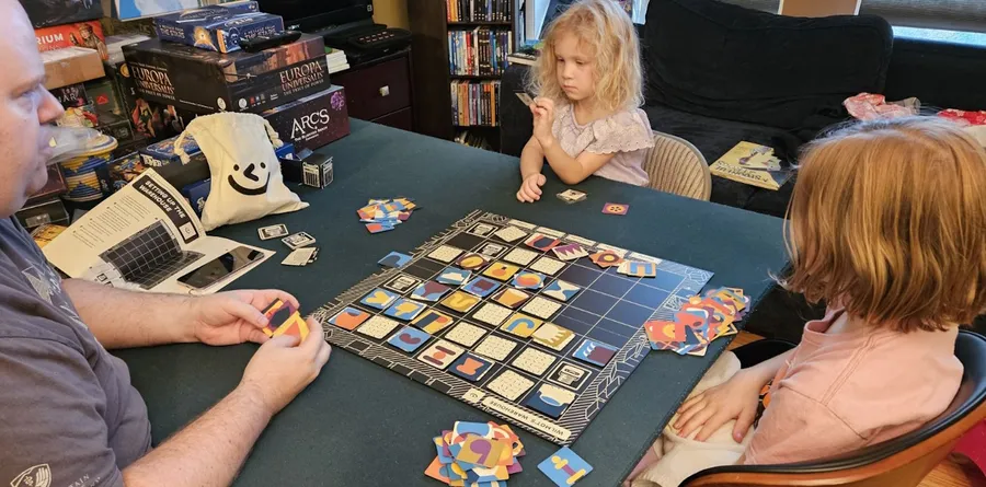 A family playing Wilmot's Warehouse at a table