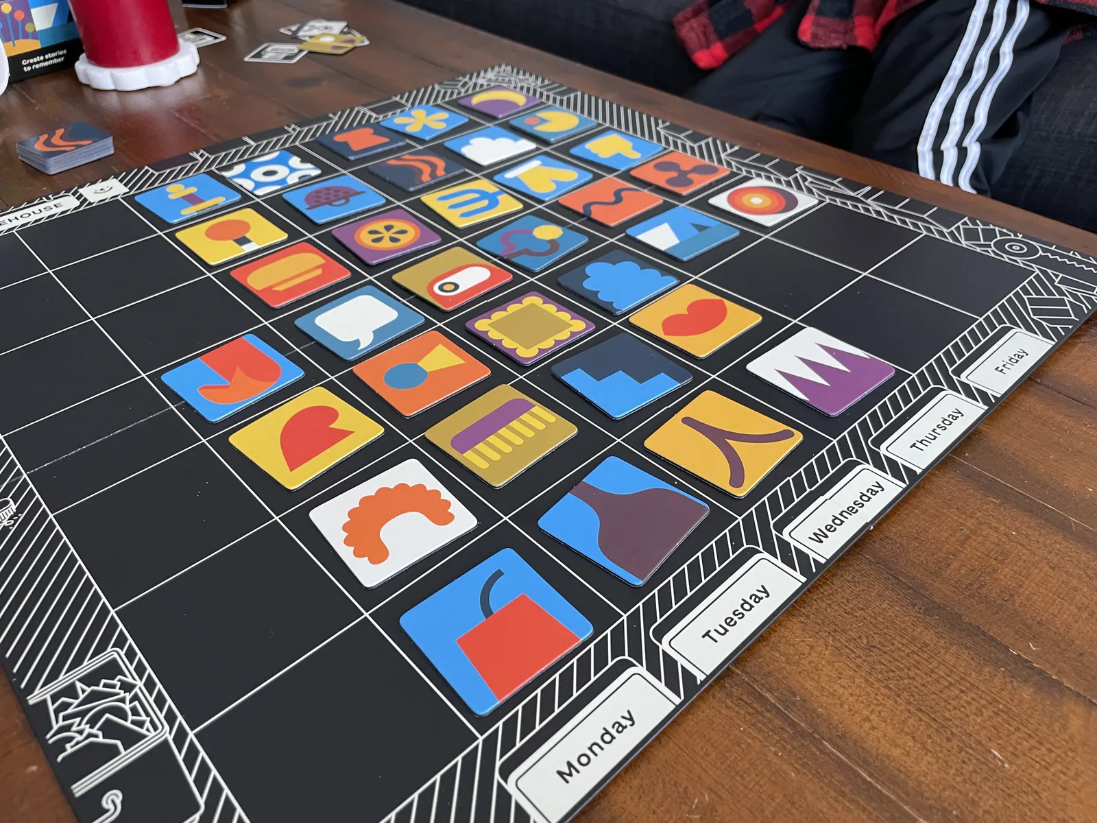 Colorful product tiles stacked beside the board